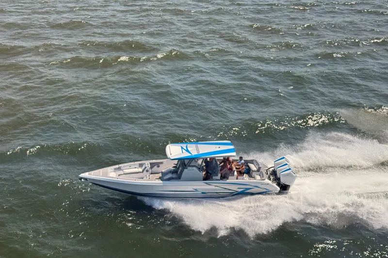 Slide: The Image of 2024 Donzi 39 VRZ speedboat cruising on open water, side view. - 87