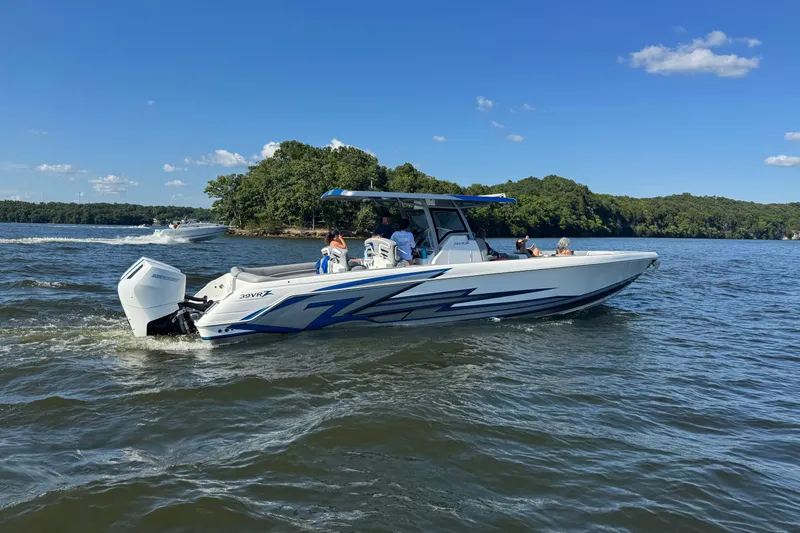 Slide: The Image of 2024 Donzi 39 VRZ boat cruising on a lake under a clear blue sky. - 90