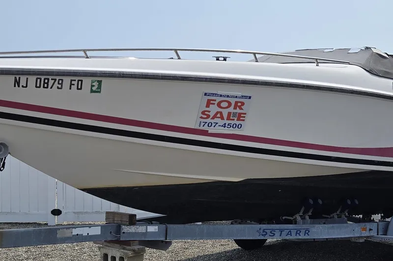 The Image of 1990 Baja 250 ES boat on trailer with pink and black stripes. - 0