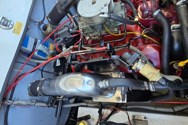 Slide: The Image of Engine compartment of a 1990 Baja 250 ES boat, showcasing detailed mechanical components. - 10