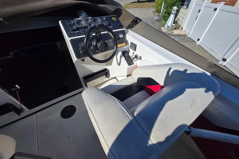 Slide: The Image of Interior of a 1990 Baja 250 ES boat showing steering wheel and dashboard controls. - 4