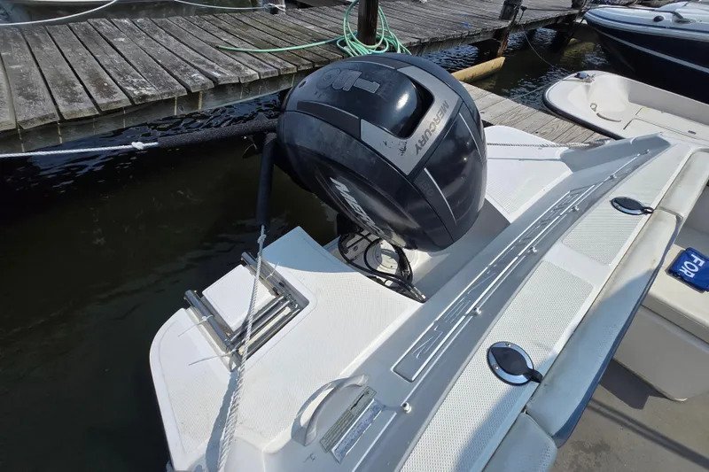 Slide: The Image of 2012 Bayliner 190 Bowrider with outboard motor docked at marina. - 15