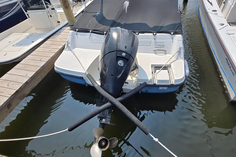 Slide: The Image of 2012 Bayliner 190 Bowrider docked, featuring an outboard motor and covered seating area. - 3