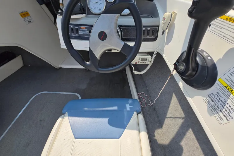 Slide: The Image of 2012 Bayliner 190 Bowrider cockpit with steering wheel and control panel. - 7
