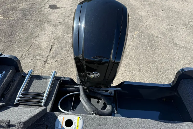 Slide: The Image of 2021 Lund 1675 Adventure Sport boat with outboard motor and ladder on pavement. - 11