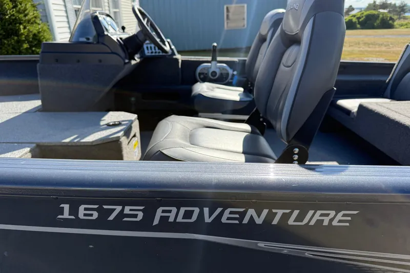 Slide: The Image of 2021 Lund 1675 Adventure Sport boat interior with seating and steering console. - 4