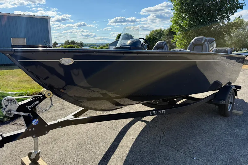 Slide: The Image of 2021 Lund 1675 Adventure Sport boat on trailer, parked outdoors under a sunny sky. - 5