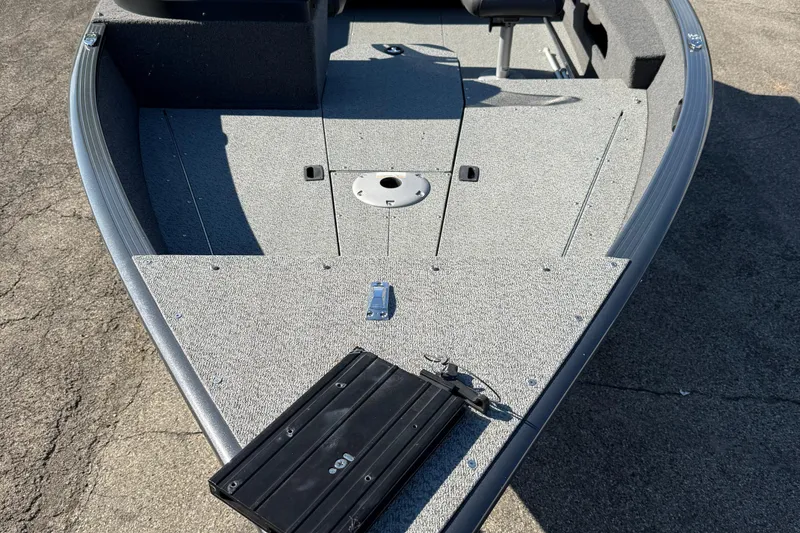 Slide: The Image of 2021 Lund 1675 Adventure Sport boat deck with seating and storage compartments. - 9