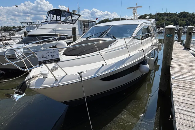 The Image of 2018 Sea Ray Sundancer 460 yacht docked at marina under clear skies. - 1