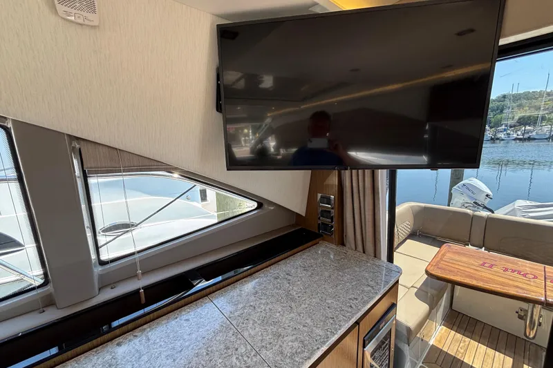 Slide: The Image of Interior of 2018 Sea Ray Sundancer 460 yacht with TV and marina view. - 12
