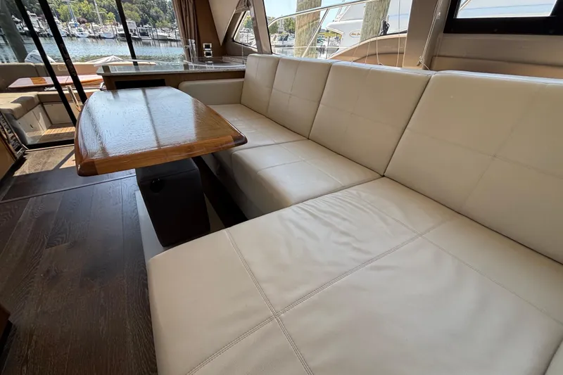 Slide: The Image of Luxurious interior of 2018 Sea Ray Sundancer 460 yacht with plush seating and wooden table. - 13