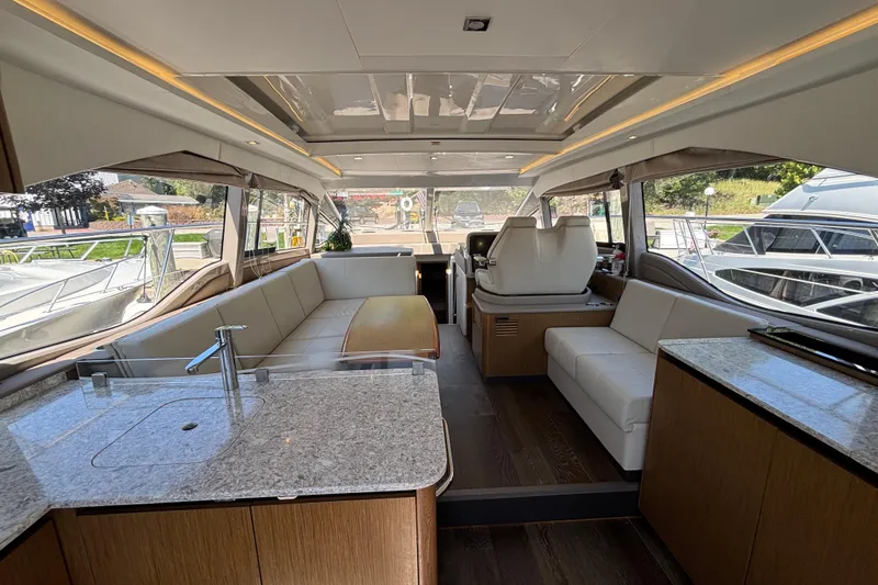 Slide: The Image of Luxurious interior of 2018 Sea Ray Sundancer 460 yacht with modern seating and kitchen area. - 16