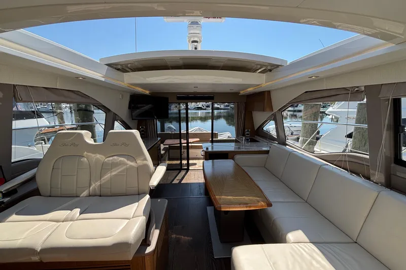 Slide: The Image of Luxurious interior of 2018 Sea Ray Sundancer 460 yacht with elegant seating and marina view. - 17