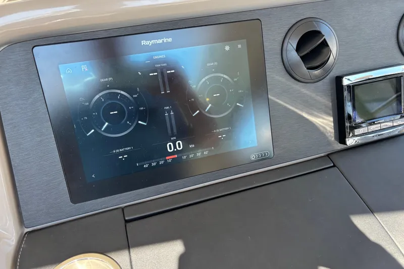Slide: The Image of Raymarine display on 2018 Sea Ray Sundancer 460 dashboard, showing engine and navigation data. - 23