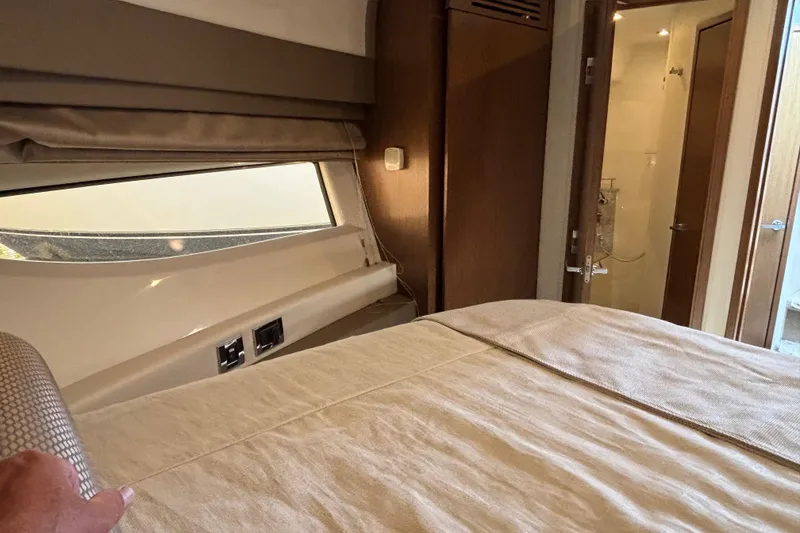 Slide: The Image of Interior cabin of 2018 Sea Ray Sundancer 460 yacht with bed and bathroom view. - 28