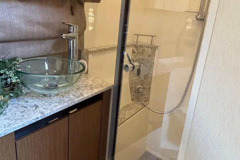 Slide: The Image of Luxurious bathroom in 2018 Sea Ray Sundancer 460 yacht with glass sink and modern shower. - 33