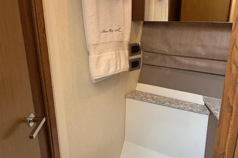 Slide: The Image of Interior of 2018 Sea Ray Sundancer 460 yacht, featuring elegant bathroom design with towel and mirror. - 34