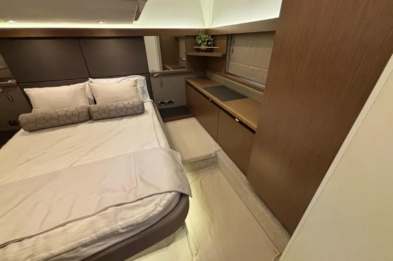 Slide: The Image of Luxurious 2018 Sea Ray Sundancer 460 cabin interior with elegant bedding and wood finishes. - 35