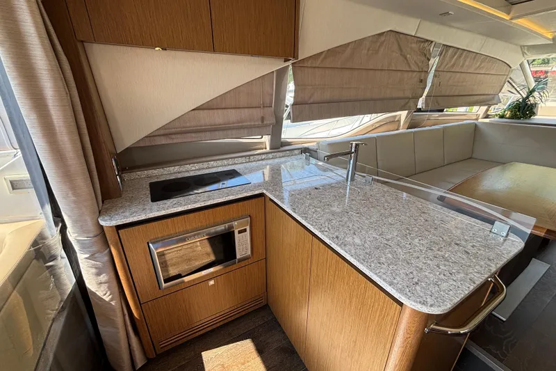 Slide: The Image of Luxurious 2018 Sea Ray Sundancer 460 yacht interior with modern kitchen and seating area. - 7
