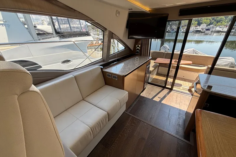 Slide: The Image of Luxurious interior of 2018 Sea Ray Sundancer 460 yacht with elegant seating and scenic marina view. - 8