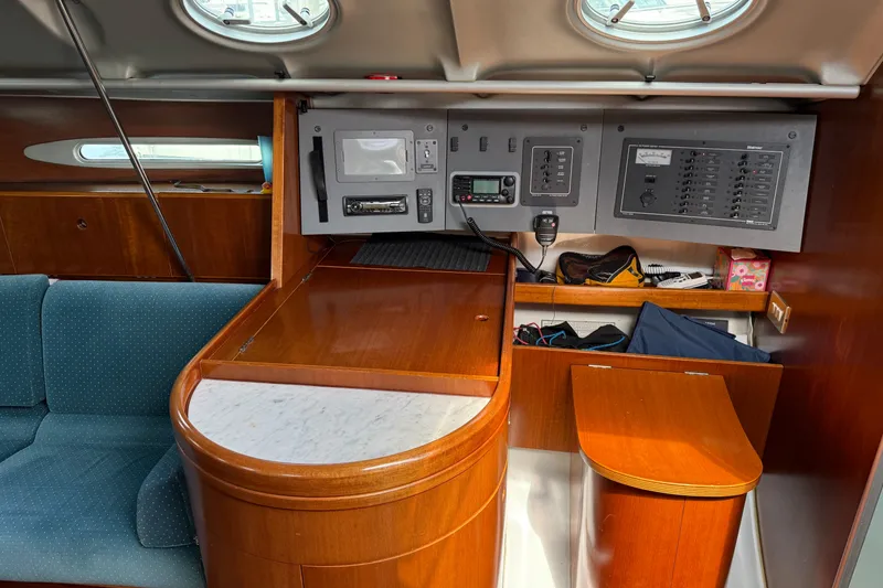 Slide: The Image of Interior of 1994 Beneteau First 35s-7 yacht with navigation equipment and seating area. - 11