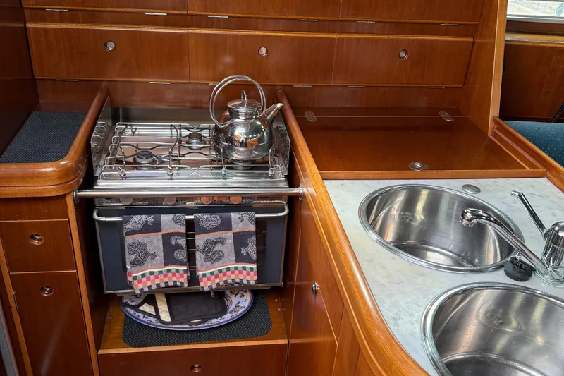 Slide: The Image of Galley of 1994 Beneteau First 35s-7 yacht with stove, kettle, and sink. - 18
