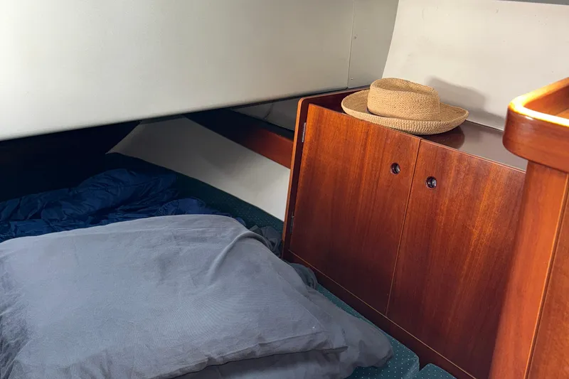 Slide: The Image of Cozy cabin interior of 1994 Beneteau First 35s-7 with wooden cabinet and straw hat. - 20