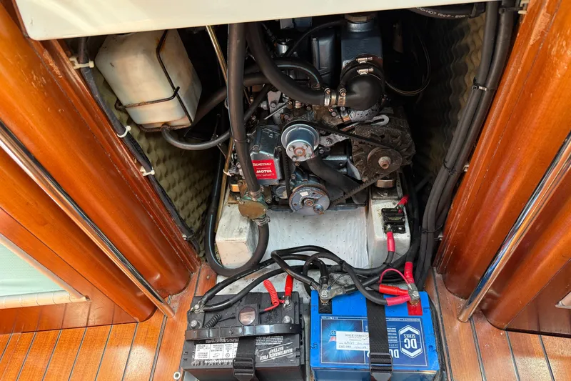Slide: The Image of Engine compartment of a 1994 Beneteau First 35s-7 sailboat with visible batteries and components. - 23