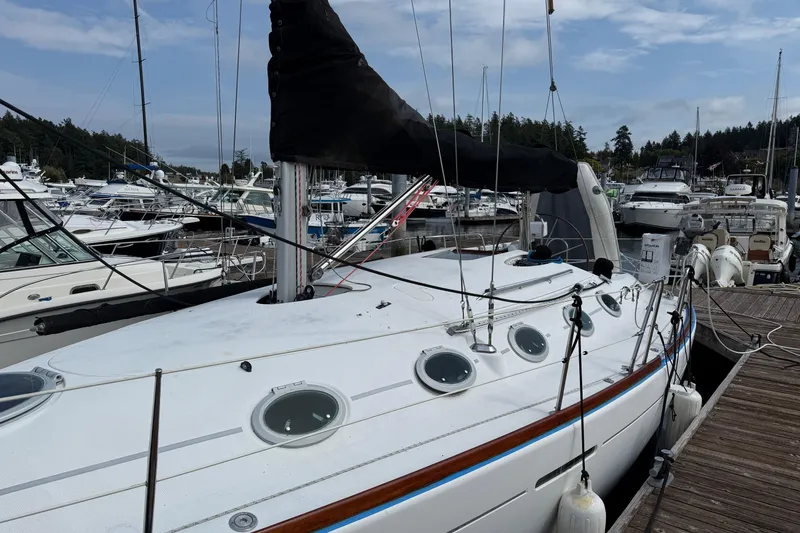 Slide: The Image of 1994 Beneteau First 35s-7 sailboat docked at a marina, surrounded by other boats. - 7