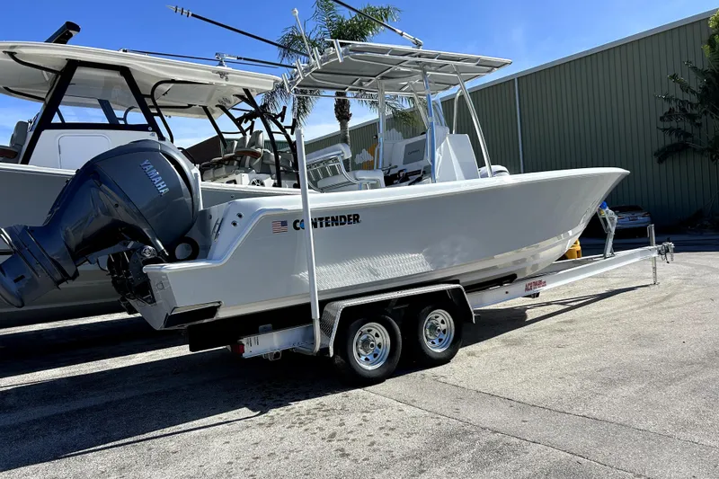 Slide: The Image of 2025 Contender 25 Tournament boat on trailer with Yamaha outboard engine. - 11
