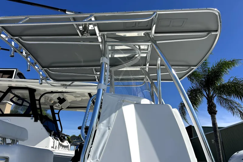 Slide: The Image of 2025 Contender 25 Tournament boat with sleek T-top design under clear blue sky. - 12