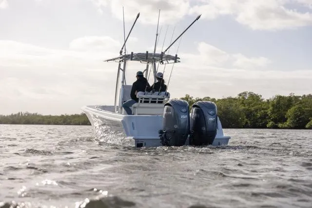 Slide: The Image of 2025 Contender 25 Tournament boat with dual engines on open water, two people aboard. - 2