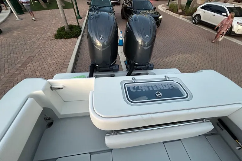 Slide: The Image of 2025 Contender 25 Tournament boat with dual engines, parked on a brick-paved street. - 26