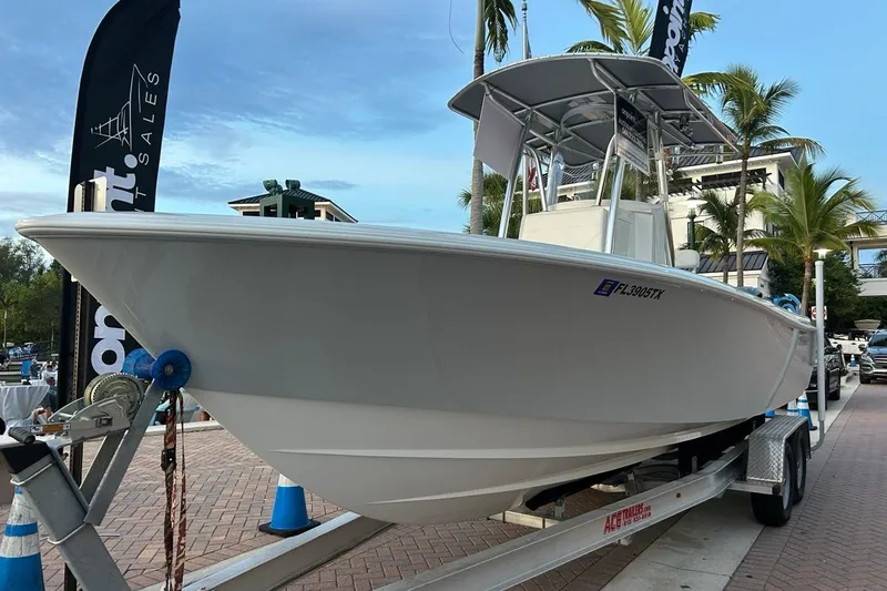 Slide: The Image of 2025 Contender 25 Tournament boat on trailer, displayed outdoors with palm trees. - 27