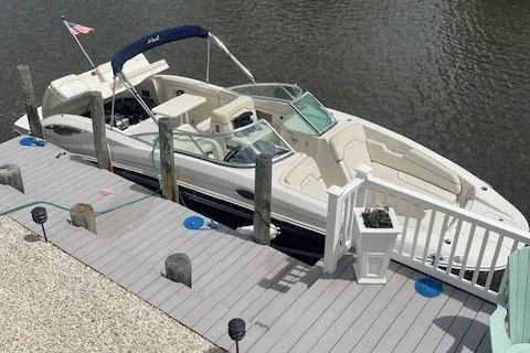 The Image of 2008 Sea Ray 290 Sundeck boat docked in a canal with American flag. - 0