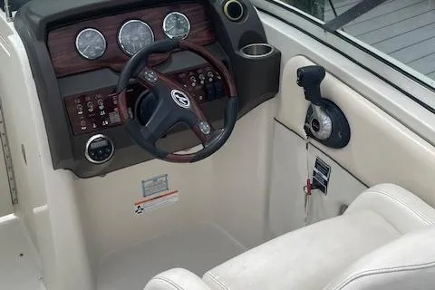 Slide: The Image of 2008 Sea Ray 290 Sundeck helm with gauges, steering wheel, and controls. - 2