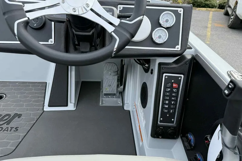 Slide: The Image of 2026 Ranger Z521 boat dashboard with steering wheel, gauges, and control panel. - 16
