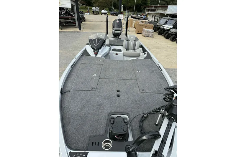 Slide: The Image of 2026 Ranger Z521 boat with spacious deck and modern seating in a showroom. - 9