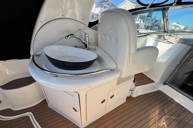 Slide: The Image of 2008 Sea Ray 340 Sundancer boat interior with sink and seating area. - 10