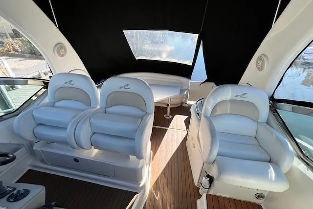 Slide: The Image of 2008 Sea Ray 340 Sundancer interior with plush seating and wood flooring. - 12