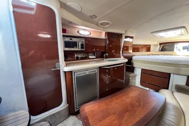 Slide: The Image of Interior of 2008 Sea Ray 340 Sundancer yacht with kitchenette and sleeping area. - 14