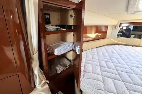 Slide: The Image of 2008 Sea Ray 340 Sundancer cabin with wooden storage and bed. - 19