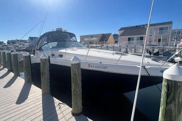 Slide: The Image of 2008 Sea Ray 340 Sundancer docked at marina under clear blue sky. - 2