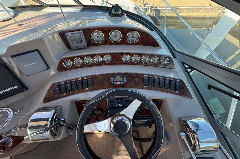 Slide: The Image of 2004 Four Winns 378 Vista boat dashboard with gauges, steering wheel, and navigation controls. - 10