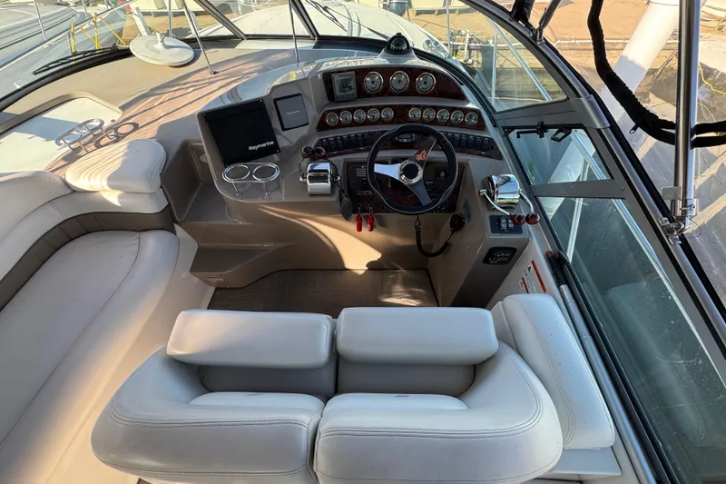 Slide: The Image of 2004 Four Winns 378 Vista boat cockpit with steering wheel and control panel. - 11