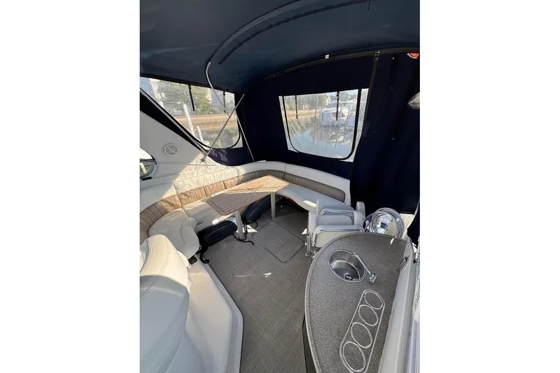 Slide: The Image of 2004 Four Winns 378 Vista boat interior with seating, table, and sink. - 15