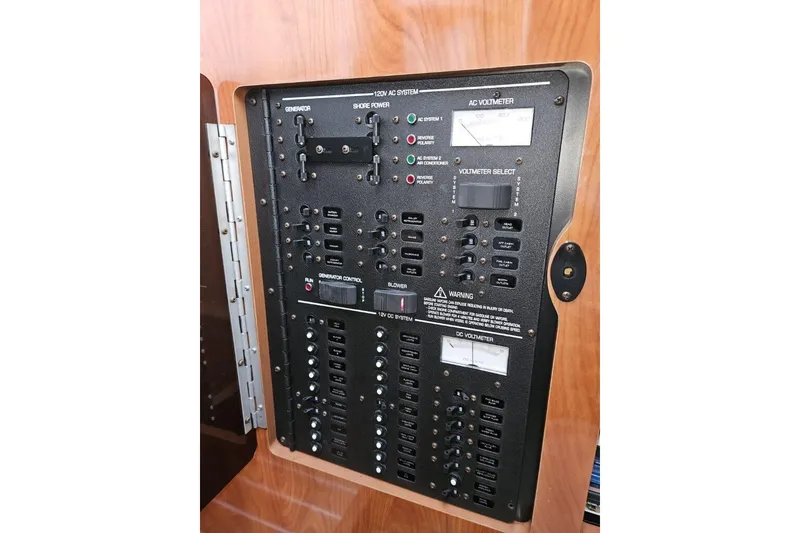 Slide: The Image of Electrical control panel of 2004 Four Winns 378 Vista boat, featuring generator and shore power systems. - 19