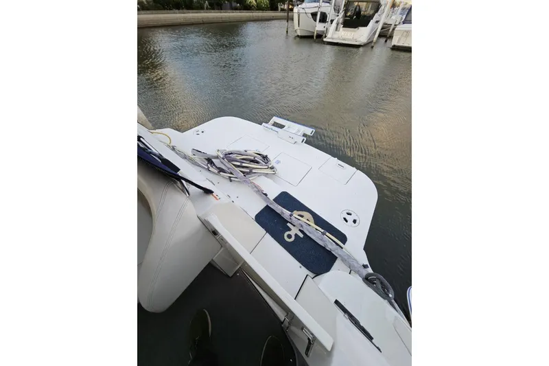 Slide: The Image of 2004 Four Winns 378 Vista boat docked, view of stern and water. - 21