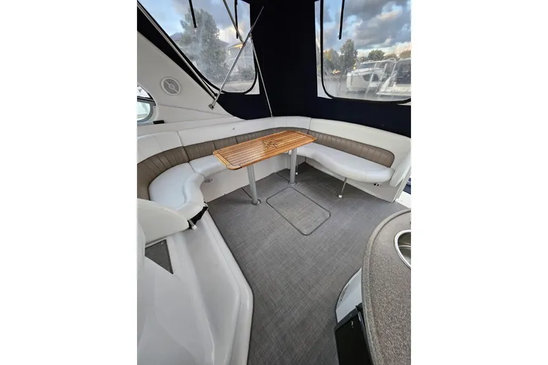 Slide: The Image of 2004 Four Winns 378 Vista interior with seating and wooden table. - 23