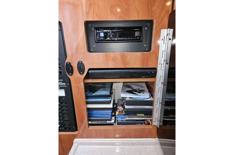 Slide: The Image of 2004 Four Winns 378 Vista interior with stereo system and DVD collection. - 25